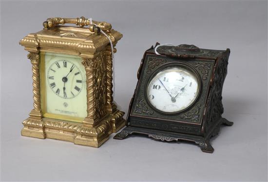 A gold-plated pocket watch in cast brass enclosed watch stand and an Ansonia Clock Co. gilt metal carriage clock, height 8cm & 11cm